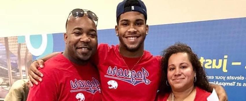 Parents with student in airport with jags shirts on.